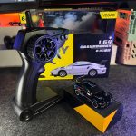 Black BMW M4 1:64 Mini Alloy RC Drift Car by YEGAO with blue red racing graphics, black wheels and rear spoiler