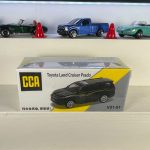 Toyota Land Cruiser Prado black 1:64 diecast SUV with gold side graphics, alloy base and CCA box packaging