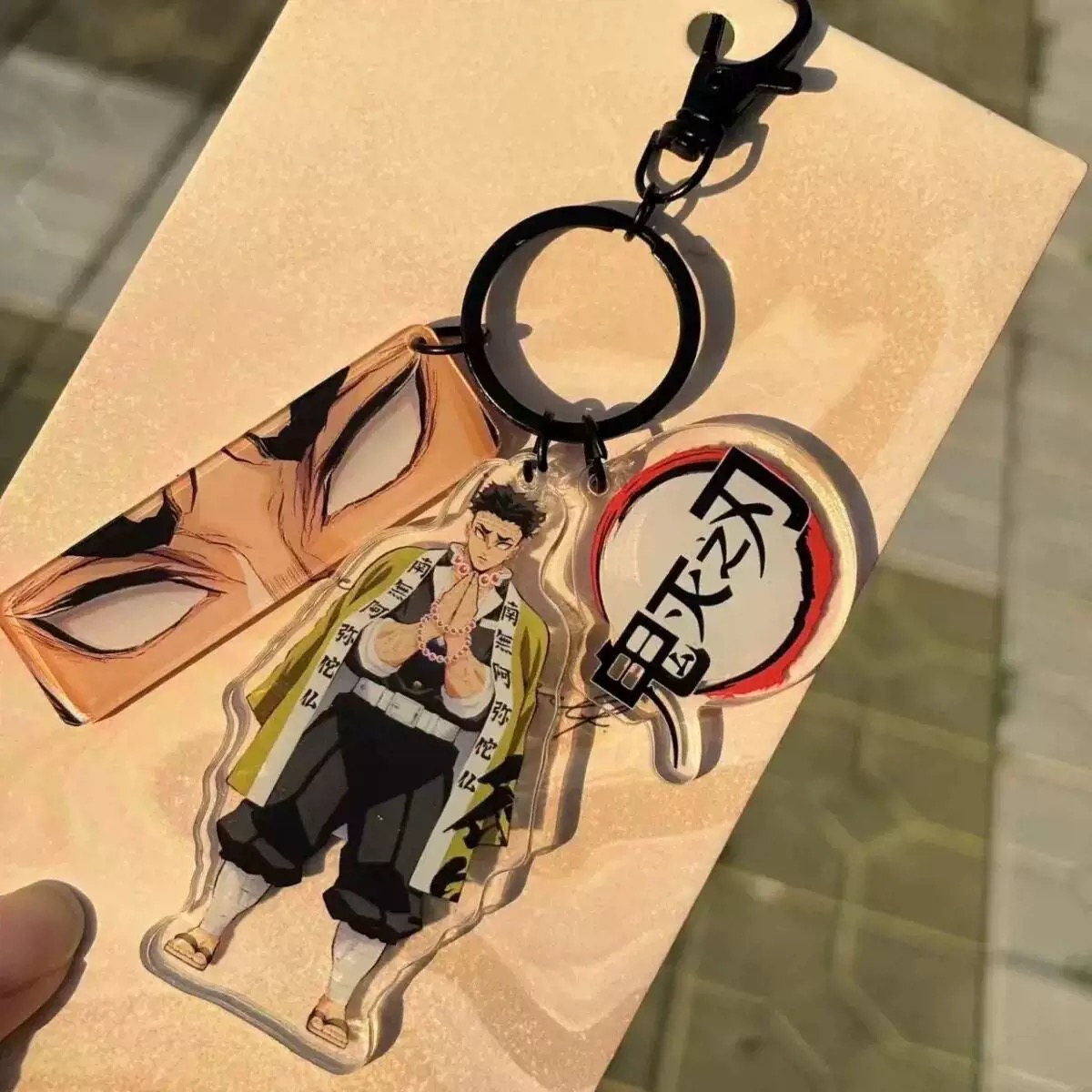 Gyomei Himejima Keyring with three Demon Slayer anime charms and Stone Hashira character artwork Gyomei Himejima Keyring with three Demon Slayer anime charms and Stone Hashira character artwork