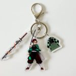 Tanjiro Kamado Sword Keyring with action-pose character, flame sword and checkered haori acrylic charms